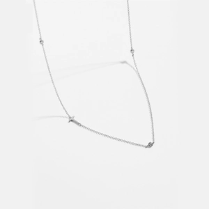 Detailed close-up of a silver-plated necklace featuring sparkling inset round rhinestones