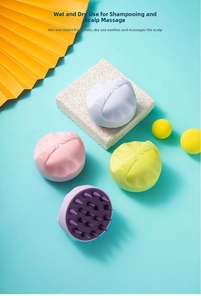 Silicone scalp massager brushes in four colors on a modern decorative background