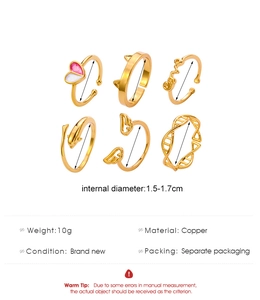 Detailed view of 6-piece copper ring set featuring heart, dolphin, and wing motifs