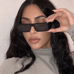 Chic women's small rectangular black sunglasses with dark lenses and minimalist frame