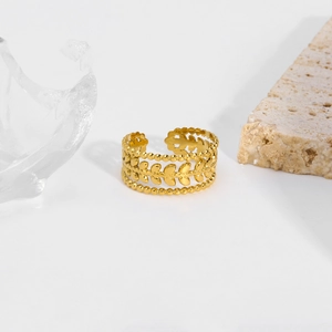 Vintage hollow leaf 18K gold-plated titanium steel ring on natural stone display
