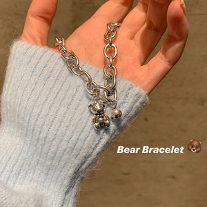 Close-up of adjustable silver link bracelet featuring a cute bear and bead charm