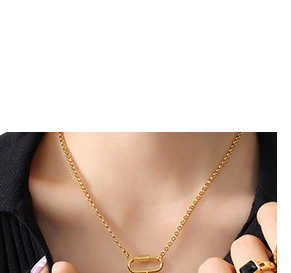 Detail of a gold minimalist chain necklace with a carabiner clasp pendant on black knit