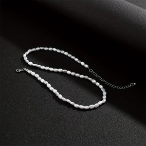 Detail of vintage hip hop pearl necklace with silver lobster clasp and extension chain