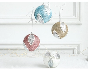 Detailed view of glittering Christmas balls with silver leaf patterns in multiple colors