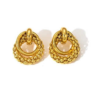 Detail of gold double-hoop earrings featuring woven texture and polished inner band finish