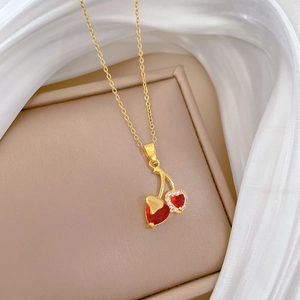 Titanium steel necklace featuring a cherry pendant with red hearts and crystals on beige box