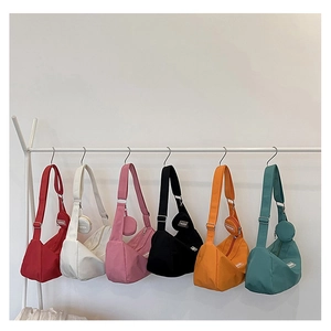 Detailed display of crescent shoulder bags in six vibrant colors with matching coin purses