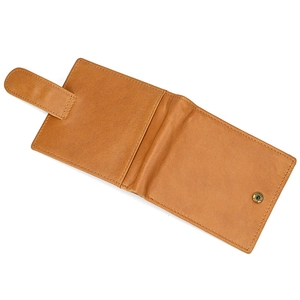Detail view of a vintage brown leather bifold wallet with a snap closure and fine texture