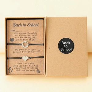 Detail of mother and daughter heart bracelets on a Back to School poem card and gift box