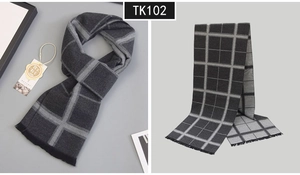 Detail shot of men's dark grey plaid wool scarf featuring fine fringe and classic patterns