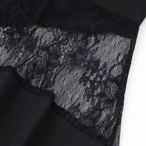 Elegant black bodycon dress featuring intricate lace patchwork and mesh fabric details
