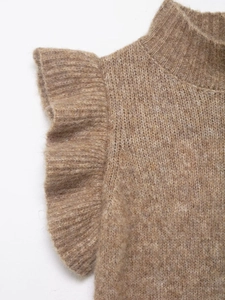 Close-up of the fuzzy knit texture and ruffle sleeve detail on a brown pullover