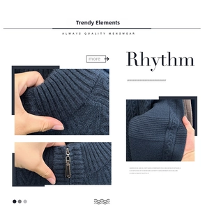 Detailed view of the dark blue cable knit sweater featuring a ribbed collar and metal zipper