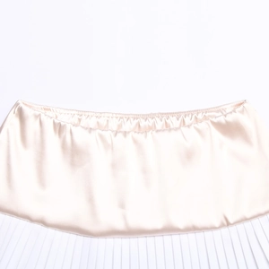 Detail of champagne satin fabric waist with white pleated texture and fine stitching