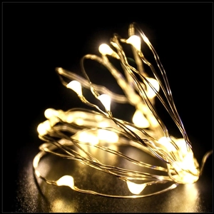 Close-up of warm white LED fairy lights with battery pack for Christmas tree decoration