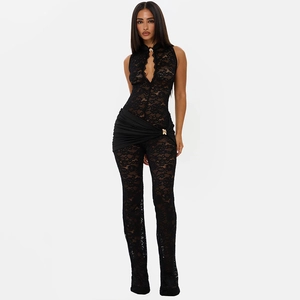 Detail showing sheer black lace sleeveless jumpsuit with waist ruching and gold hardware