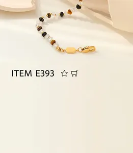 Detailed view of beaded bracelet with tiger eye beads and golden lobster clasp