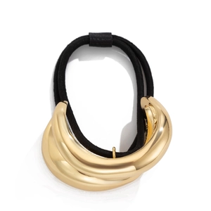 Close-up of a glossy gold geometric square metal buckle on a black elastic hair tie