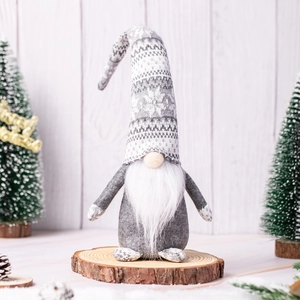 Handmade Christmas gnome plush with grey snowflake hat on rustic wood stand decoration