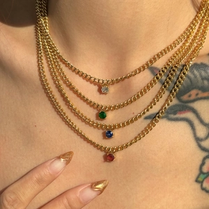 Detail of four-layered 18k gold plated stainless steel necklaces with colorful zircons