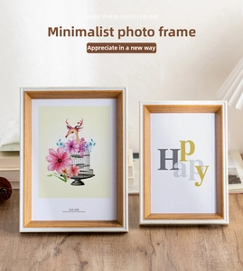 Close-up of solid wood photo frames with dual-color grain design on a wooden desk