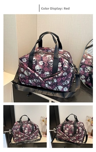 Close-up of red gothic travel bag featuring skull and rose pattern with durable handles