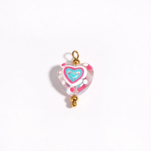 Detailed view of handmade pink heart lampwork glass bead with gold connector for DIY jewelry