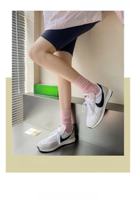 Detail of pink cotton slouch socks featuring hollow-out geometric patterns and wide ribbed cuffs