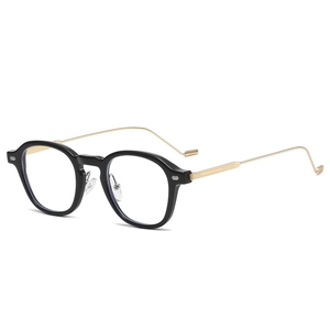 Classic black and gold round frame glasses with retro metal temples in 3/4 view