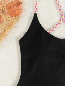 Classic black one-piece swimsuit with colorful braided straps and glittery fabric