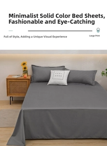 Detail view of dark grey washed cotton bedding set including flat sheet and pillowcases