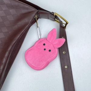 Detailed close-up of a pink plush rabbit coin purse charm with silver ball chain