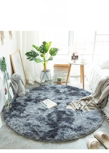 Detail of soft smokey-grey round shaggy rug with fluffy texture for home living room