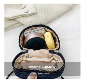 Macro view of internal capacity showing cosmetics inside the blue quilted denim bag