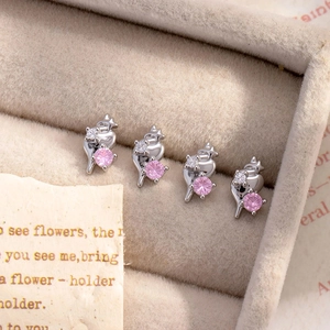 Pink zircon ice cream cone earrings in silver setting displayed on velvet