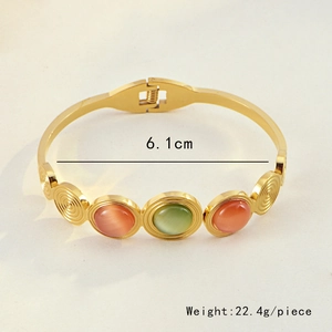 Detail view of bohemian gold bracelet with green cat-eye stones, inner diameter 6.1cm
