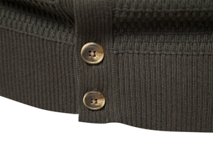 Detail of dark olive knit fabric with textured brown buttons on a men's cardigan sweater