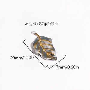 Macro detail of leaf pendant showing dimensions 29x17mm and weight 2.7g in silver and gold