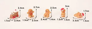 Detailed measurement view of miniature resin gingerbread man and Christmas train figurines
