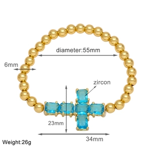 Detailed size guide of gold beaded cross bracelet with blue cubic zirconia charms