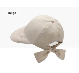 Detail of beige cotton sun hat featuring a stylish back bow decoration and twill texture