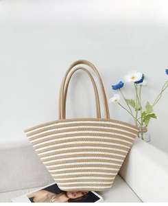 Detail of hand-woven striped cotton tote bag in khaki and white on a soft cream sofa