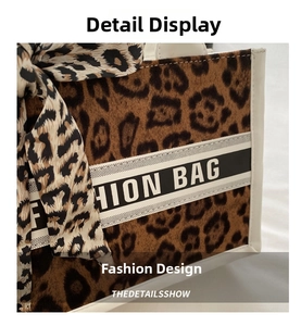 Detail of leopard print tote bag with contrast webbing and decorative silk scarf