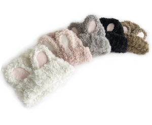 Detail of plush bunny ear headbands in various colors including white, pink and brown