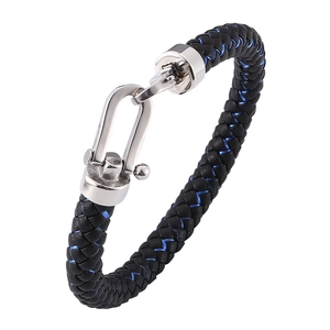 Close-up of black braided leather bracelet with blue accents and silver horseshoe buckle