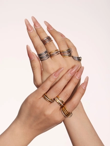 Close-up of stacked multi-layer mixed metal rings with cubic zirconia inlay details