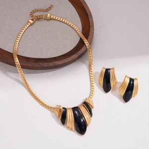 Retro vintage gold alloy necklace and earring set with black enamel ribbed details
