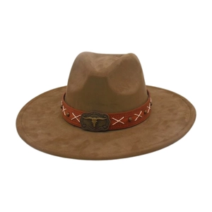 Detail of brown fedora hat featuring an ethnic leather band and bull skull buckle.