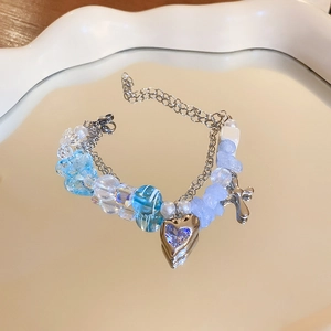 Detailed macro view of heart pendant beaded bracelet with blue glass and pearls